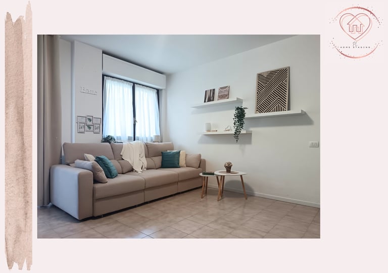 Minimalist living room with beige sofa, floating shelves, small side table, and large window with natural light