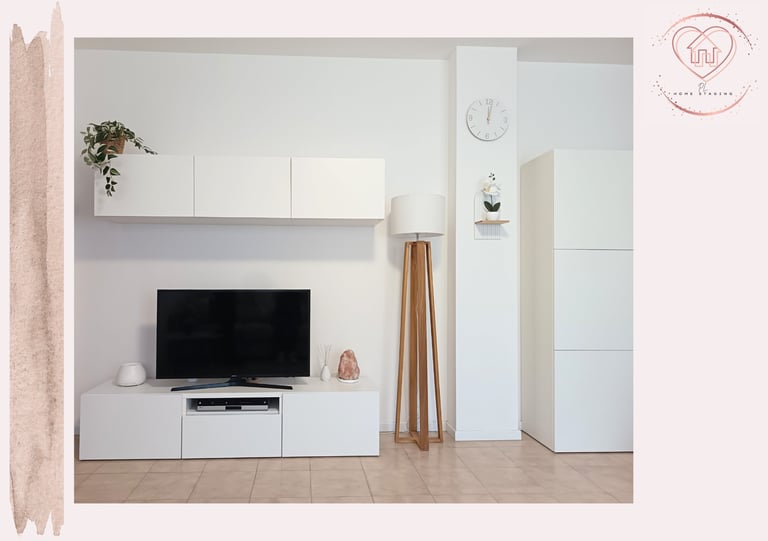 Modern minimalist living room with white wall-mounted media cabinet, flat-screen TV, wooden shelving, and light wooden flooring